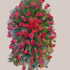 Standing floral spray of red roses and carnations with ribbon