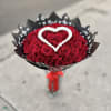 Bouquet of red roses with a white heart accent in black wrap