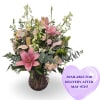 Soft pink lilies take center stage in this garden-style flower arrangement, a