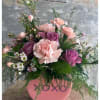 Pink and Purple carnations with pretty wax flowers arranged in a "XOXO"