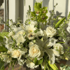All-white ceramic vase arrangement with roses, lilies, gerbera, ranunculus and green orchids