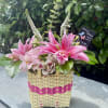 Pink lilies and alstroemeria in a woven basket