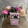 Pink and purple tulips and roses arranged in a sweet "kissing both"