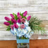 Pops of tulips paired with pale blue hydrangea are such a sweet
