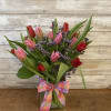 20 Lovely tulips arranged in a clear glass vase. Color will vary
