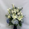 Blue and white calla lilies and roses meet lush blue hydrangeas in