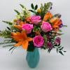 A vibrant, feel-good arrangement bursting with color and charm.
Designed in a soft