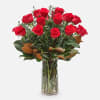 Red roses arranged in a clear glass vase