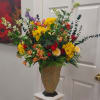 A towering, celebratory mixed flower arrangement built to catch the eye -