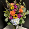 A bright elegant garden of Sunflowers, Hydrangea, Stock, Roses, and seasonal foliage.