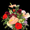 Mixed bouquet with red roses and peach calla lilies in a vase