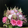 Pink and white bouquet of roses and peonies in a glass vase