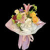 Pastel bouquet with lilies, hydrangea, and ranunculus wrapped in pink paper