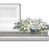 An all Blue, white tribute, this half casket spray is pure in