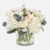 This luxurious vase arrangement combines the delicate beauty of  white hydrangeas