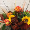 To get this look, arrange sunflowers, cockscomb, calla , pin cushion protea