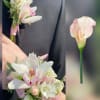 A delicate pairing of mini calla lilies, and roses makes this prom