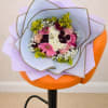 A riot of pink gerbera daisies and soft pink roses makes an