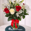 Red and ivory roses paired with white lilies create a classic romantic