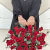 Red roses beautifully arranged with Eucalyptus in between. Arrangement is in a
