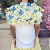 Beautiful arrangement in white color with cute blue butterflies on top
