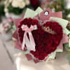 A dense heart of deep red roses shaped into a classic heart