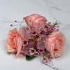 A cluster of blush pink roses accented with tiny pink filler blooms