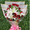 An elegant bouquet of 12 red roses and 3 lilies, wrapped in