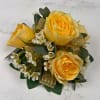 Four pale yellow spray roses form the heart of this wrist corsage