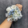White alstroemeria wrist corsage with white tulips , blue filler accents and