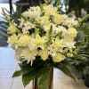 Tall golden cyclinder vase with fresh white flowers. (NOTE: if you rather