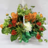 Bright orange lilies and velvety orange roses create a joyful, eye-catching bouquet