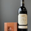 Wine bottle beside a box of gray and smoked salt caramels