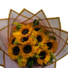 Bouquet of yellow sunflowers and roses wrapped in translucent paper
