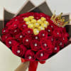 Bouquet of red roses with gold-wrapped chocolates and a jeweled crown