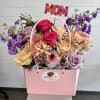 A boutique-style arrangement featuring fresh, seasonal flowers artfully designed inside a stylish