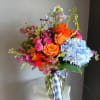 This beautiful flower arrangement of fresh mixed seasonal blooms is made by