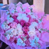 A lush, rounded bouquet of pink and white roses designed to make