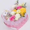 A romantic heart-shaped box filled with pastel roses and seasonal blooms, paired