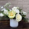 A serene, low-profile floral arrangement perfect for sympathy, a wedding table, or