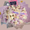 A rounded birthday bouquet of roses in soft blush, cream and lavender