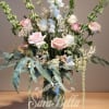 "This exquisite floral arrangement is a delicate blend of blush pink roses