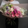 Large pastel bouquet with pink, white, and lavender flowers wrapped in blush paper