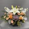 Reminiscent of a desert sunrise, this modern mix of peach blooms, white