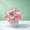 This pretty pink arrangement brings major spring vibes with garden roses, ranunculus