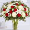 Red roses and white lilies in a clear glass vase