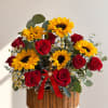 Bright yellow sunflowers and deep red roses create an immediate burst of