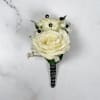Two ivory-white roses create the refined focal point of Onyx Boutonniere, a