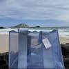 A cool, transparent blue tote with wide fabric straps and a subtle
