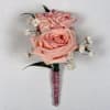 Two pale blush roses sit snugly together in this Rose Quartz boutonniere
